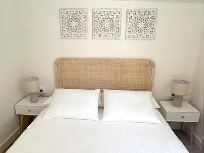 a bedroom with a bed with two night stands and two lamps at La Buganvilla in Chiclana de la Frontera