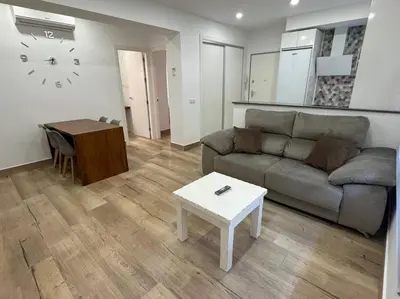 a living room with a couch and a table at El Refugio de Susana Grupo AC Gestion in Cádiz