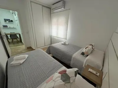 a small room with two beds and a table at El Refugio de Susana Grupo AC Gestion in Cádiz