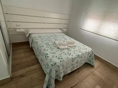 a small bedroom with a bed with two towels on it at El Refugio de Susana Grupo AC Gestion in Cádiz