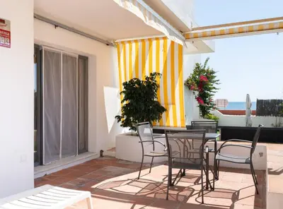 a patio with chairs and a table on a balcony at Apartoyou - Sol y Playa Goleta in El Puerto de Santa María