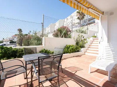 a patio with a table and chairs and stairs at Apartoyou - Sol y Playa Goleta in El Puerto de Santa María