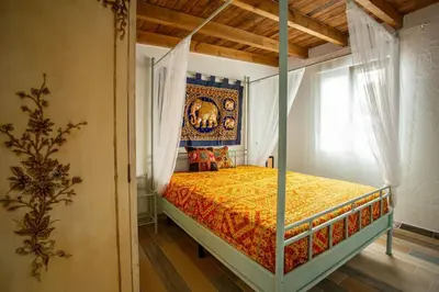 a bedroom with a canopy bed with a skull on it at Villa Tailan con piscina y jacuzzi privado in Chiclana de la Frontera