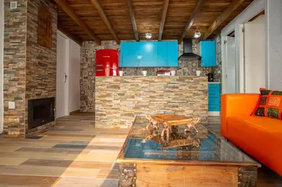 a living room with an orange couch and a fireplace at Villa Tailan con piscina y jacuzzi privado in Chiclana de la Frontera