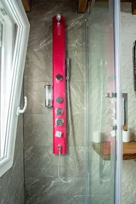 a shower with a red object on the wall at Villa Tailan con piscina y jacuzzi privado in Chiclana de la Frontera