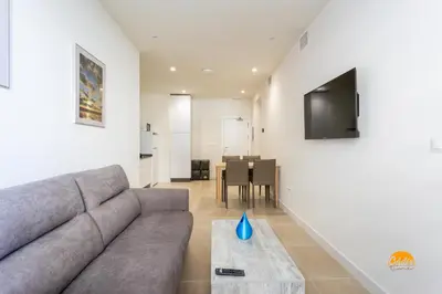 a living room with a couch and a table at Delfin Azul by Cadiz Time in Cádiz