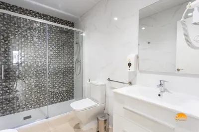 a bathroom with a toilet and a shower and a sink at Delfin Azul by Cadiz Time in Cádiz