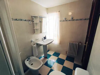 a bathroom with a sink and a toilet at Casa Comodoro in Cádiz