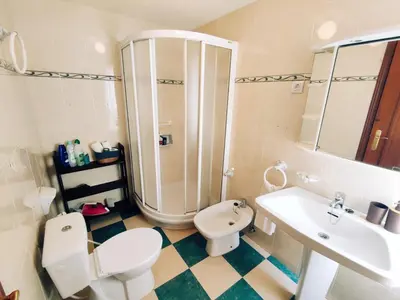 a bathroom with a shower and a toilet and a sink at Casa Comodoro in Cádiz