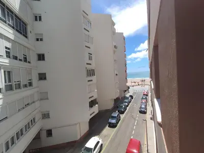 a view of a street with parked cars in a city at Casa Comodoro in Cádiz