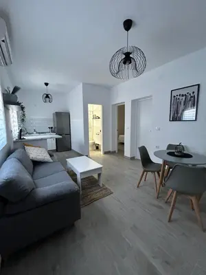a living room with a couch and a table at Capillita de Bajo Guía in Sanlúcar de Barrameda