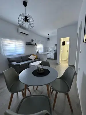 a living room with a table and chairs and a couch at Capillita de Bajo Guía in Sanlúcar de Barrameda