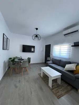 a living room with a couch and a table at Capillita de Bajo Guía in Sanlúcar de Barrameda