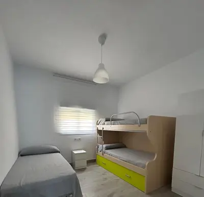 a bedroom with a bunk bed and a yellow drawer at Capillita de Bajo Guía in Sanlúcar de Barrameda