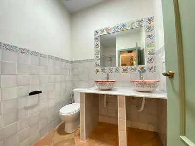 a bathroom with two sinks and a toilet at Apartamento Isaac Peral 2 in Chipiona