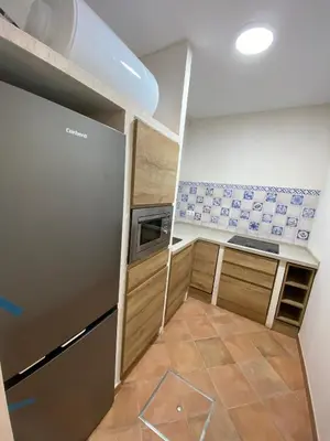 a small kitchen with a stove and a refrigerator at Apartamento Isaac Peral 2 in Chipiona