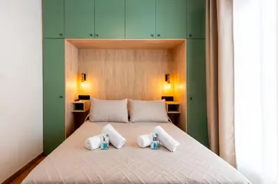 a bedroom with a bed with four pillows on it at Apartamento Isaac Peral 2 in Chipiona