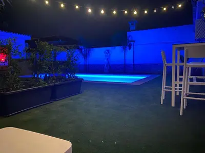a stage with two chairs and a person in the background at Musa del Paraíso in Novo Sancti Petri