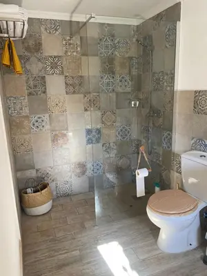 a bathroom with a toilet and a glass shower at Musa del Paraíso in Novo Sancti Petri