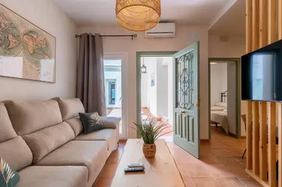 a living room with a couch and a tv at Apartamento Isaac Peral 1 in Chipiona