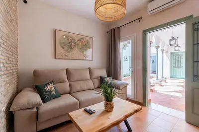 a living room with a couch and a table at Apartamento Isaac Peral 1 in Chipiona