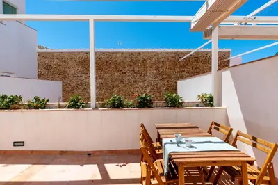 a table and chairs on a rooftop patio at Apartamento Isaac Peral 1 in Chipiona