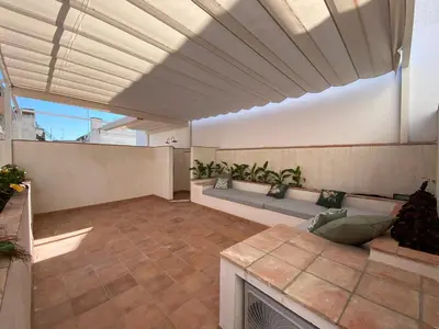an indoor patio with a couch and a fireplace at Apartamento Isaac Peral 1 in Chipiona
