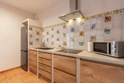 a kitchen with a sink and a microwave at Apartamento Isaac Peral 1 in Chipiona