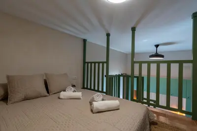 a bedroom with a bed with towels on it at Apartamento Isaac Peral 1 in Chipiona