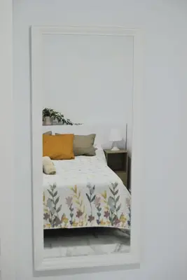 a bedroom with a bed with a mirror at Apartamento con encanto en el corazón de la ciudad in Jerez de la Frontera