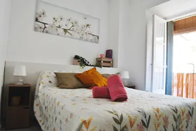 a bedroom with a bed with two pillows on it at Apartamento con encanto en el corazón de la ciudad in Jerez de la Frontera