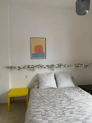 a bedroom with a bed and a yellow table at Apartamento Céntrico in El Puerto de Santa María