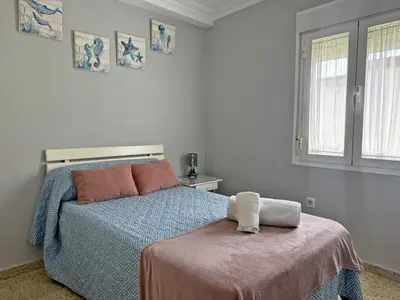 a bedroom with a bed and a window at Apartamento El Faro - Ole Solutions in El Puerto de Santa María