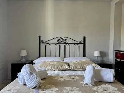 a bedroom with a bed with two pillows on it at Apartamento El Faro - Ole Solutions in El Puerto de Santa María