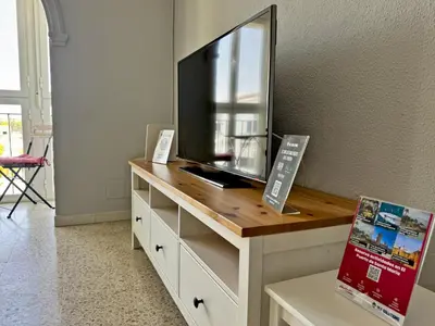 a dresser with a television on top of it at Apartamento El Faro - Ole Solutions in El Puerto de Santa María