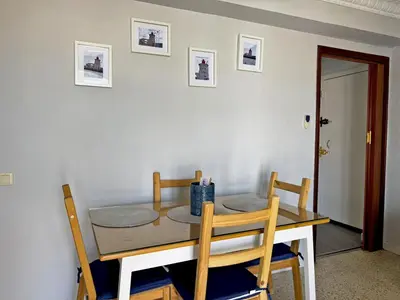 a dining room table with two chairs and a table and a table and chairsktop at Apartamento El Faro - Ole Solutions in El Puerto de Santa María