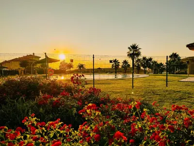 a fence with a lot of flowers in a park at Mika's House Valley in Sanlúcar de Barrameda