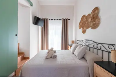 a teddy bear sitting on a bed in a bedroom at Apartamento Isaac Peral 3 in Chipiona
