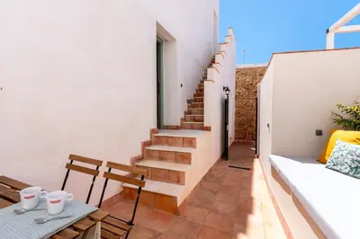 a staircase in a house with a table and chairs at Apartamento Isaac Peral 3 in Chipiona