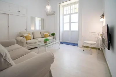 a living room with a couch and a table at Montera Suite Cádiz in Cádiz