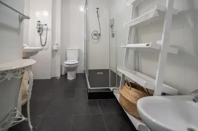 a bathroom with a toilet and a sink and a shower at Montera Suite Cádiz in Cádiz