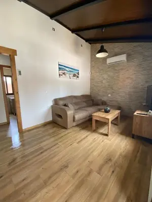 a living room with a couch and a table at Chalet con encanto en Conil SOLO FAMILIAS Y PAREJAS in Conil de la Frontera