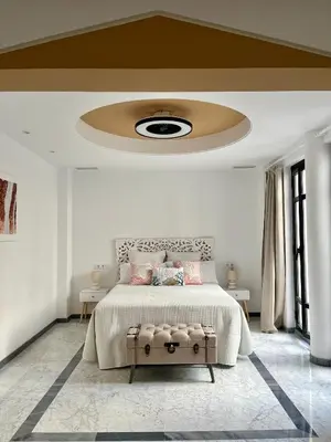 a bedroom with a large bed with a ceiling at Lindo Pisito Sanlucar Calle Ancha in Sanlúcar de Barrameda