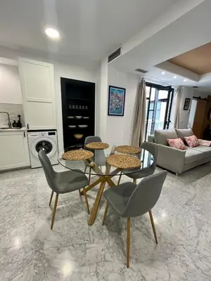 a living room with a table and chairs and a couch at Lindo Pisito Sanlucar Calle Ancha in Sanlúcar de Barrameda