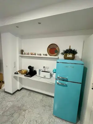 a blue refrigerator in a kitchen with a counter at Lindo Pisito Sanlucar Calle Ancha in Sanlúcar de Barrameda