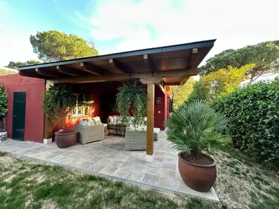 a patio with a wooden pergola at Villa Rocio in El Puerto de Santa María