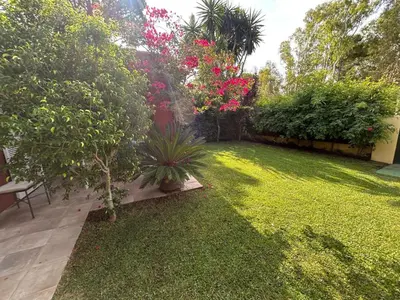a backyard with a lawn with plants and flowers at Villa Rocio in El Puerto de Santa María