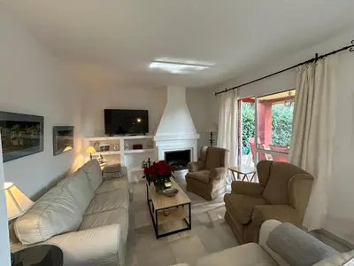 a living room with white furniture and a fireplace at Villa Rocio in El Puerto de Santa María