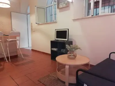 a living room with a bunk bed and a table at Vicario 11 Estudio in El Puerto de Santa María