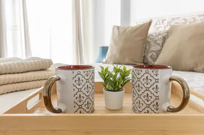 two coffee mugs sitting on a table in a living room at Puertas del Sol 11 in Jerez de la Frontera